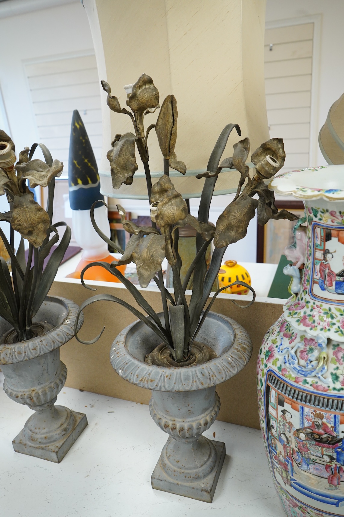 A pair of cold painted bronze floral lamps with painted cast iron campagna urns, 76cm high